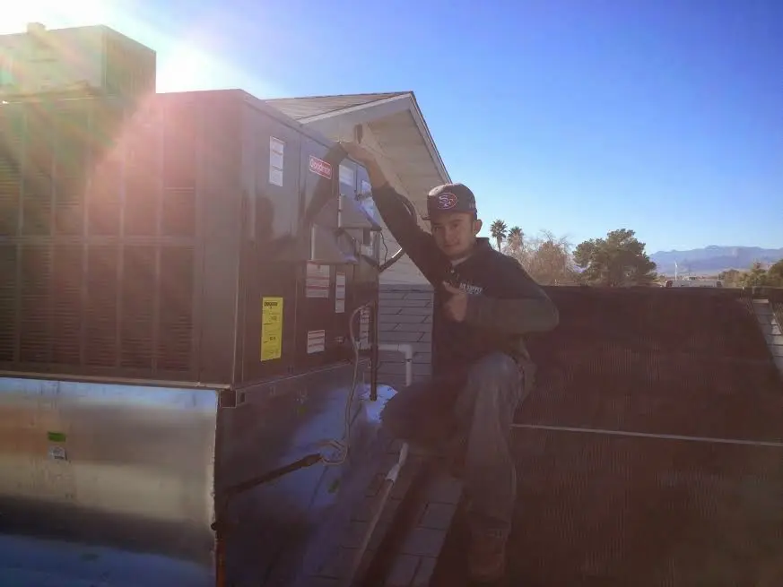 HVAC technician performing HVAC Inspection on a rooftop unit in Menlo Park